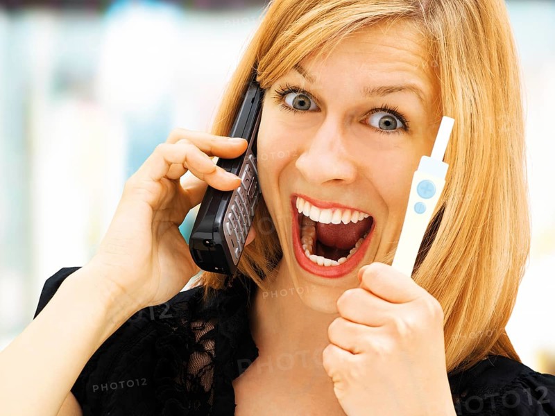 Woman holding a pregnancy test