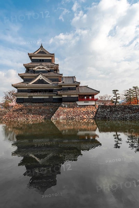 Old Japanese castle reflected in the moat