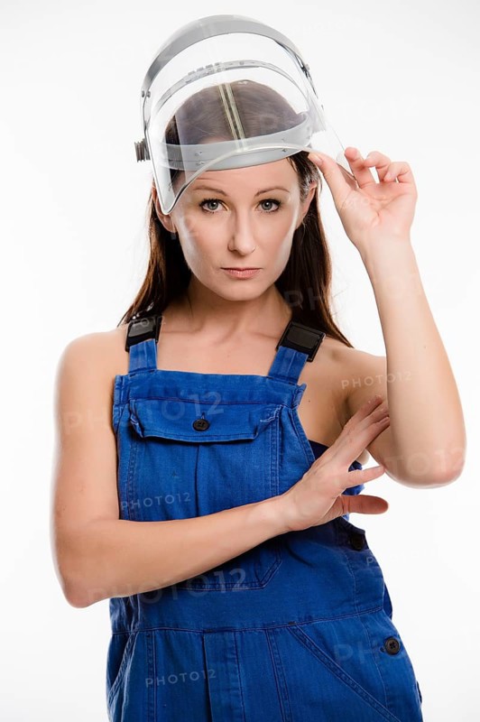 Woman wearing blue overalls and a protective helmet