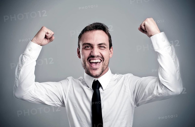 Young man wearing a shirt and a tie cheering