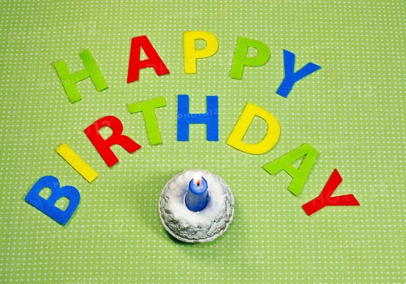 Small birthday cake and the words Happy Birthday