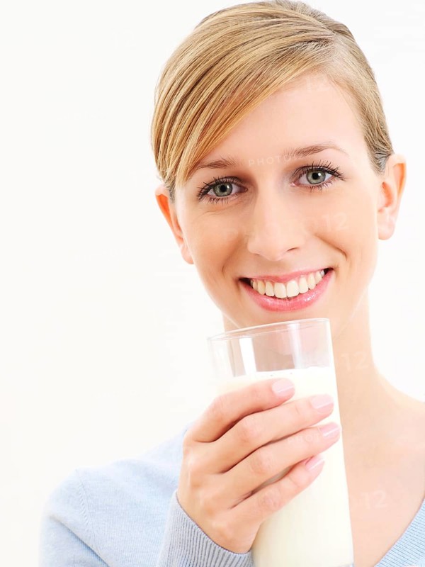 Young woman holding a glass of milk