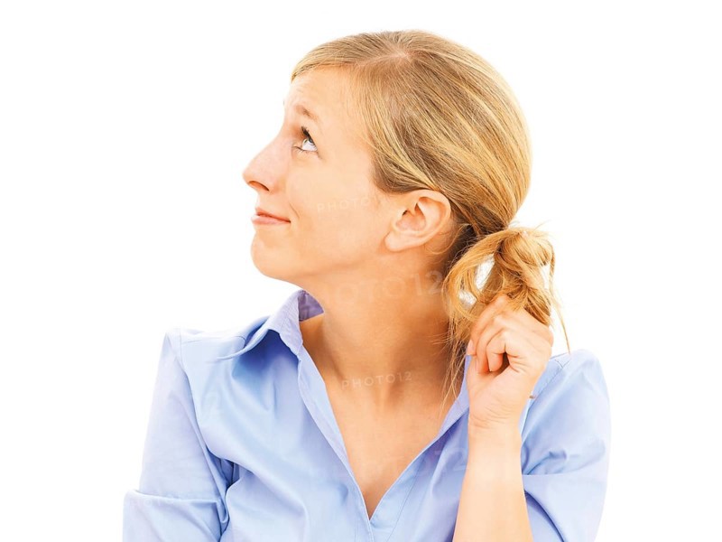 Young woman looking bashful