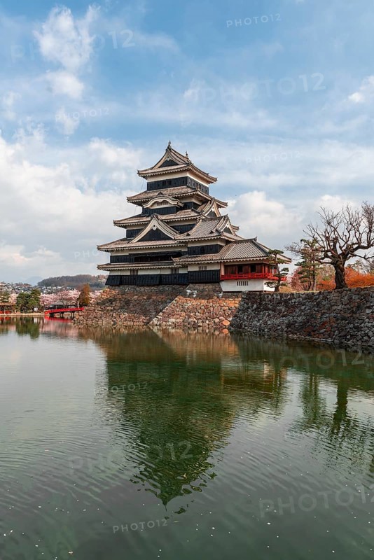 Old Japanese castle reflected in the moat