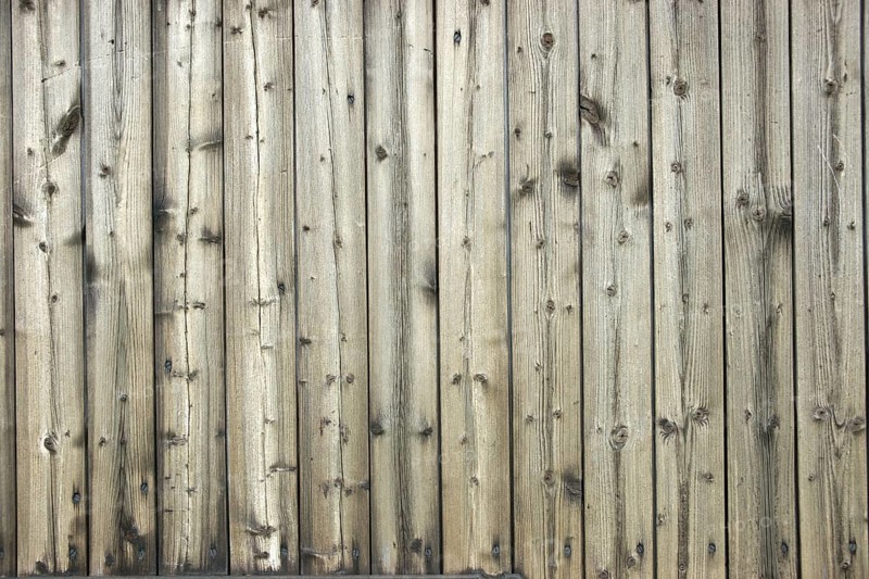 Faded wooden wall of planed boards
