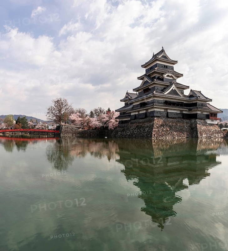 Old Japanese castle reflected in the moat