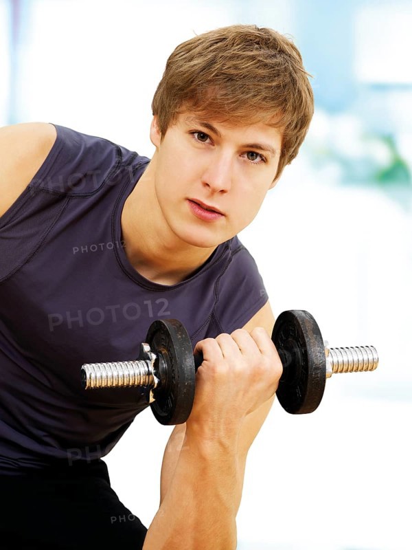 Young man doing strength training with a dumbbell