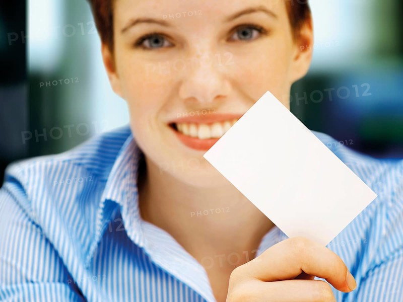 Businesswoman holding a blank business card