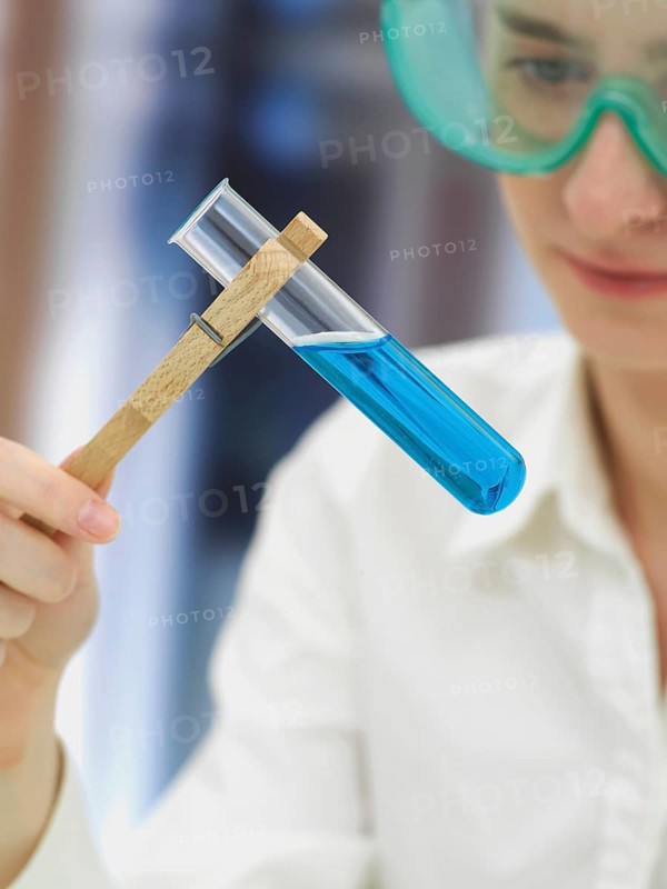 Scientist wearing a protective mask and holding a test tube