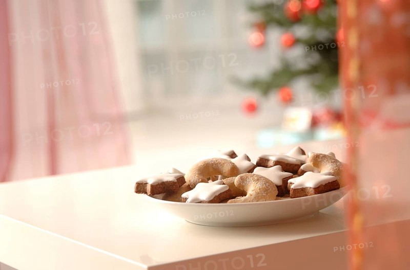 Christmas cookies on a plate in front of a Christmas tree