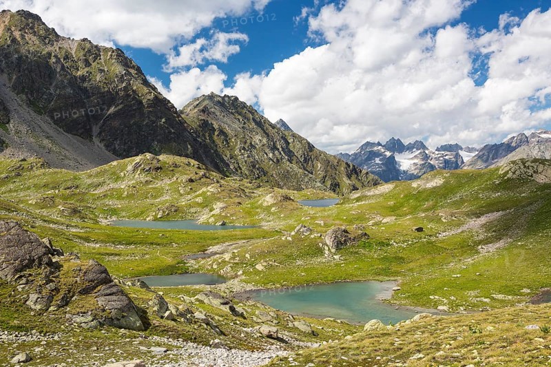 Macun plateau of lakes with views of the Verstancla group with the mountains Chaputschin and Verstanclahorn