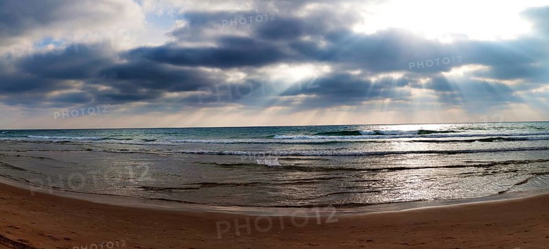 Sun rays breaking through clouds