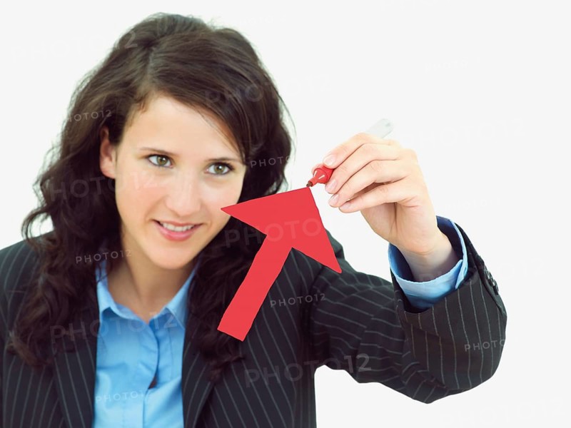 Young businesswoman drawing an arrow pointing upwards