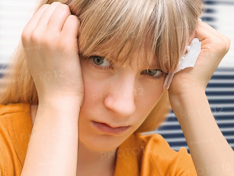 Young woman holding a tissue