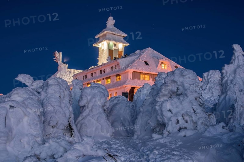 Snow-covered Fichtelberghaus in the evening in winter on the Fichtelberg mountain