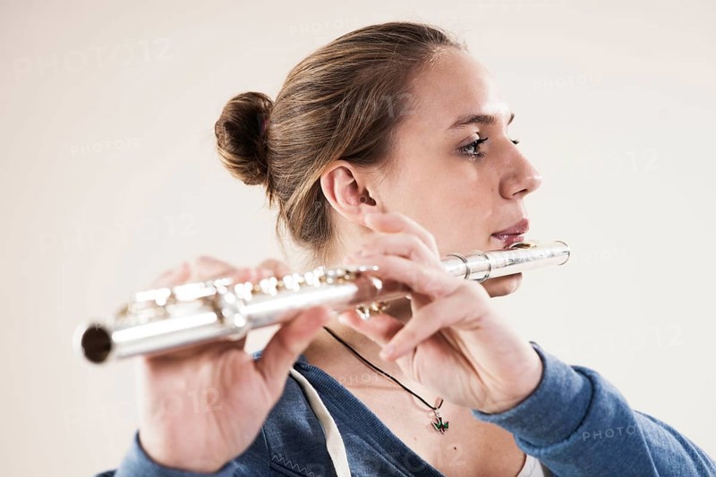 Teenage girl playing the flute