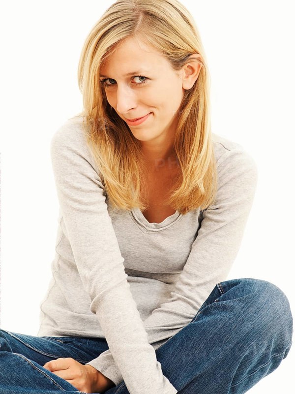 Woman smiling while sitting in a cross-legged position