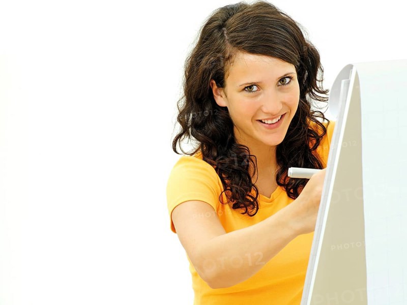 Young businesswoman standing next to a flipchart