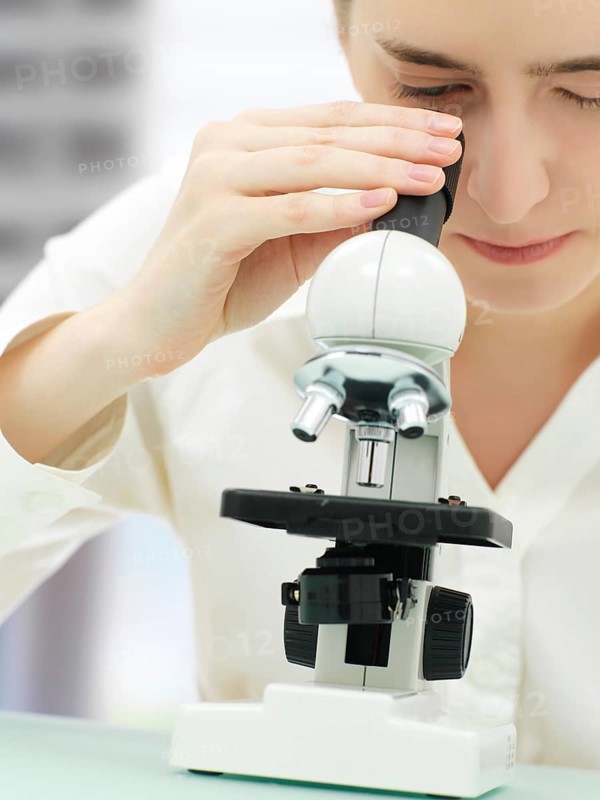 Scientist looking through a microscope