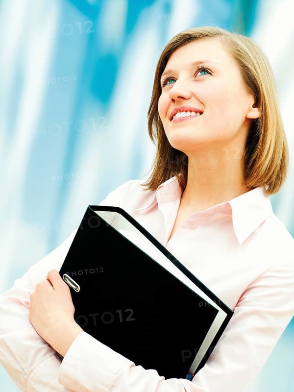 Businesswoman holding a ring binder