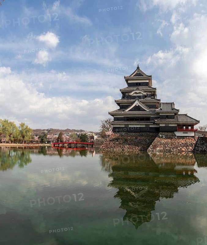 Old Japanese castle reflected in the moat