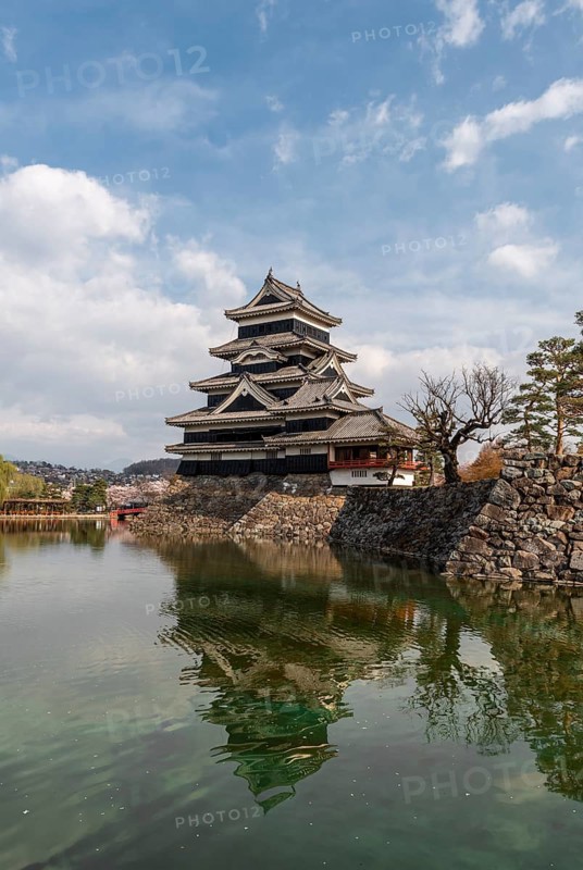 Old Japanese castle reflected in the moat