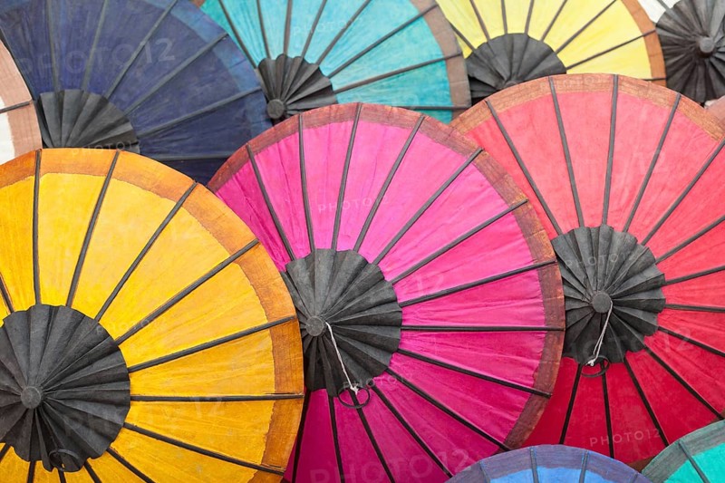 Multicoloured hand-made paper umbrellas or parasols on display at a market in Luang Prabang