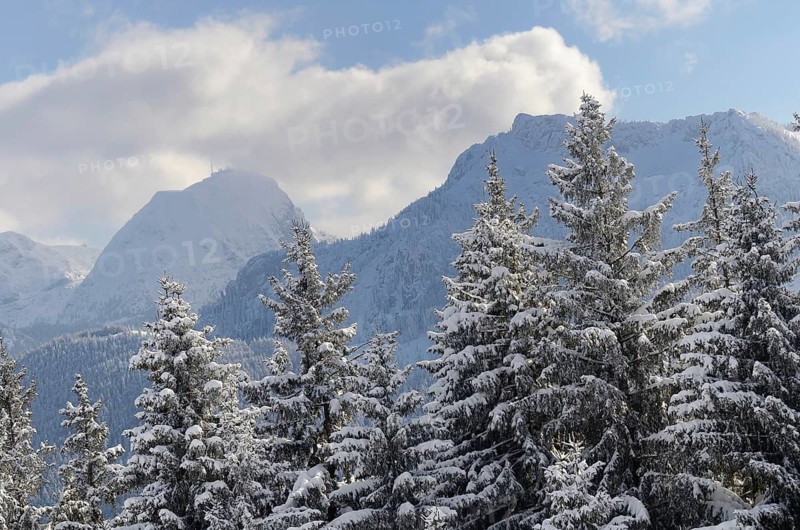 Snow clouds over winter mountain landscape