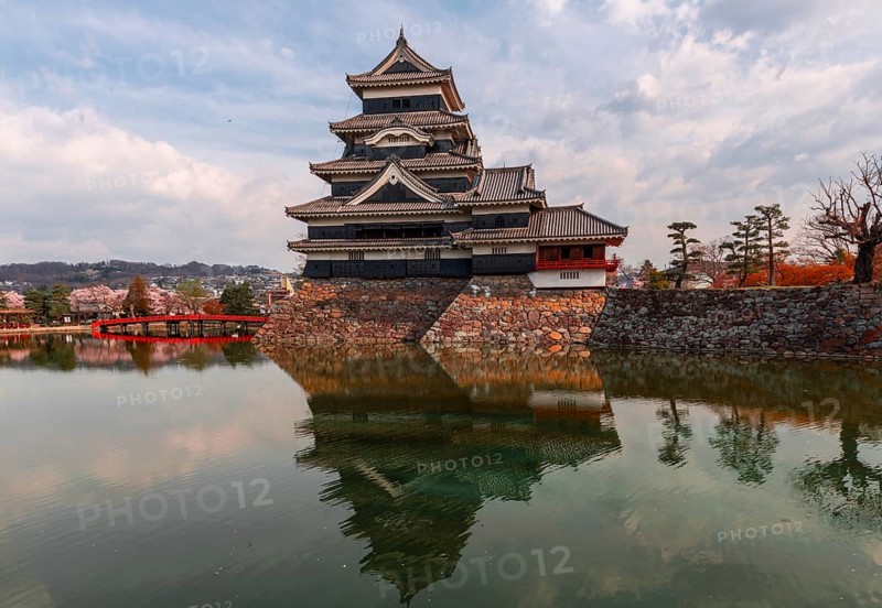 Old Japanese castle reflected in the moat