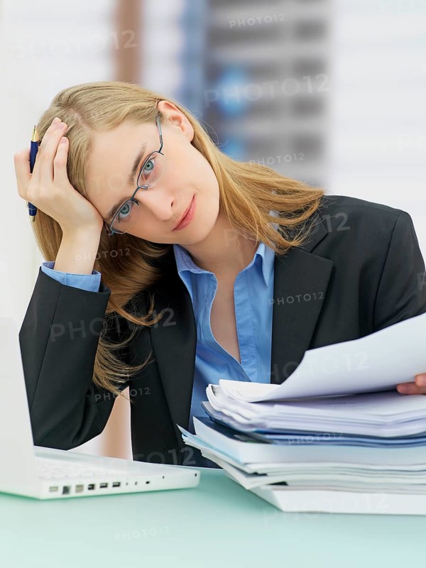 Businesswoman wearing glasses and using a laptop