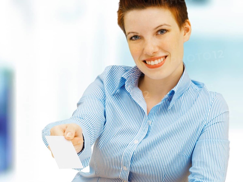 Businesswoman holding a blank business card