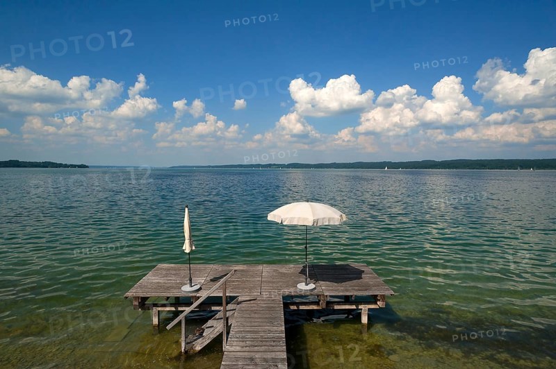 Lake Starnberg with bathing jetty and parasol