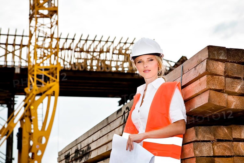A young female constructor at building of a new motorway
