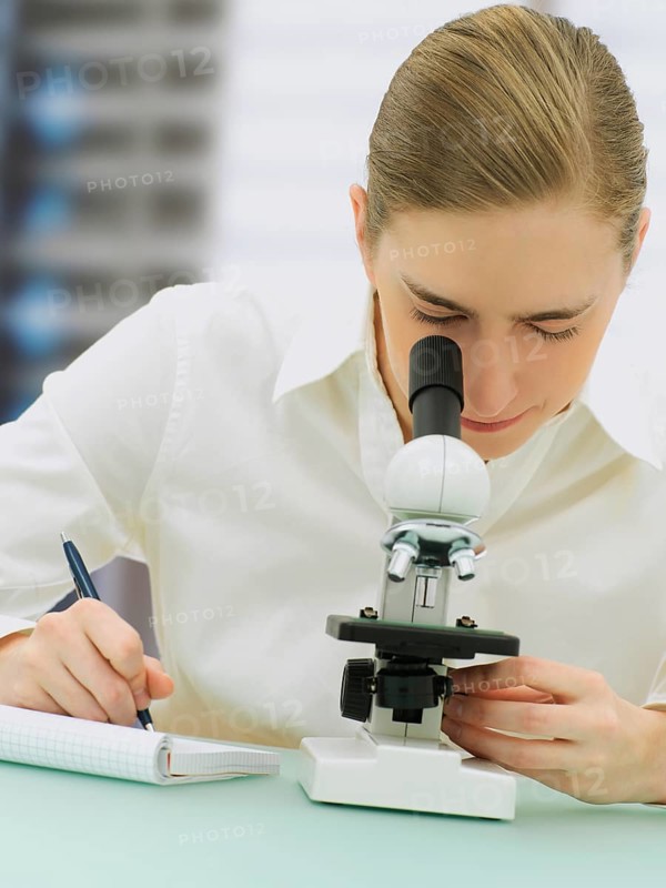 Scientist looking through a microscope