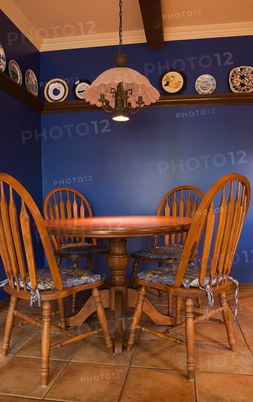 Antique table and chairs in the kitchen of a 1998 reproduction of an old Canadiana cottage style residential Home