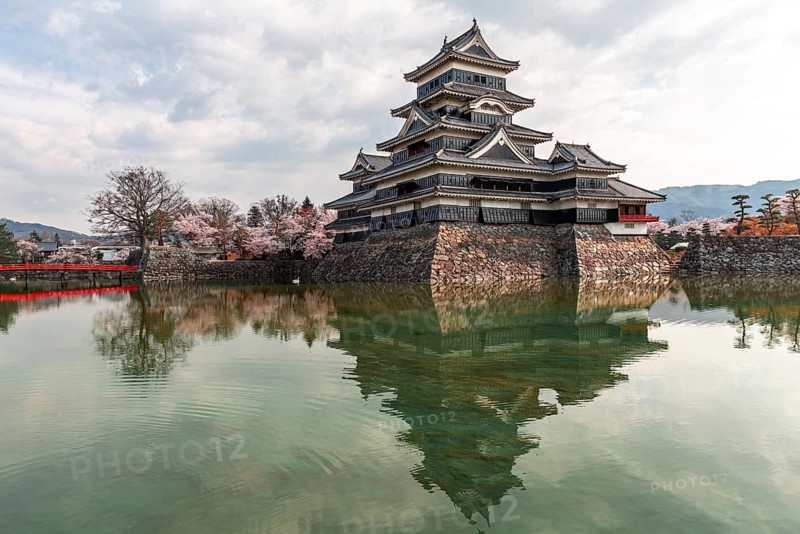 Old Japanese castle reflected in the moat