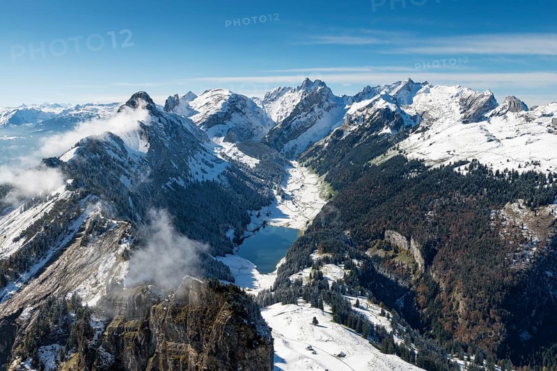 The snow-covered Appenzell Alps and lake Saemtisersee