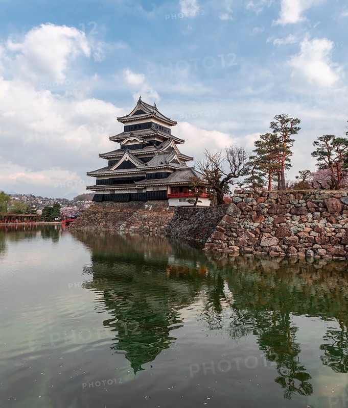 Old Japanese castle reflected in the moat