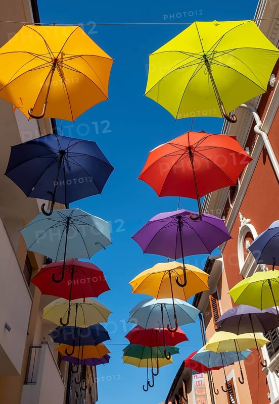 Colorful umbrellas over a road
