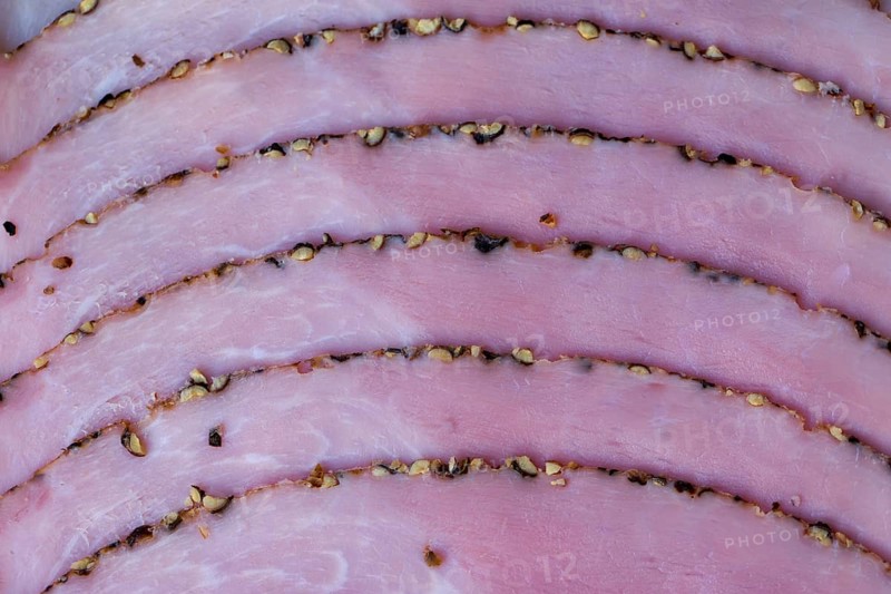 Slices of smoked ham with pepper
