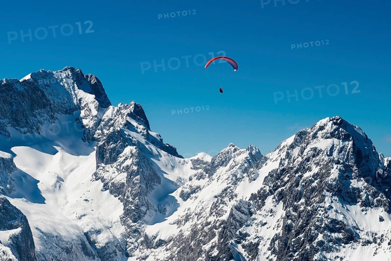 Paraglider pilot in front of Zugspitze and Waxenstein