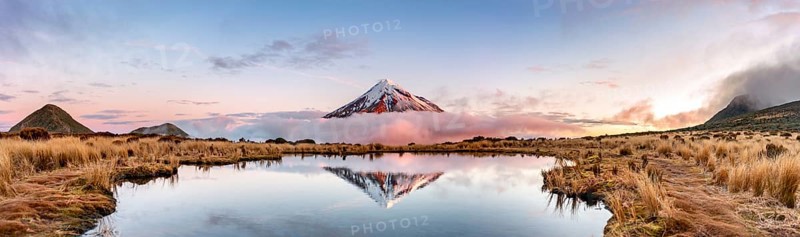 Water reflection in Pouakai Tarn Mountain Lake at sunset