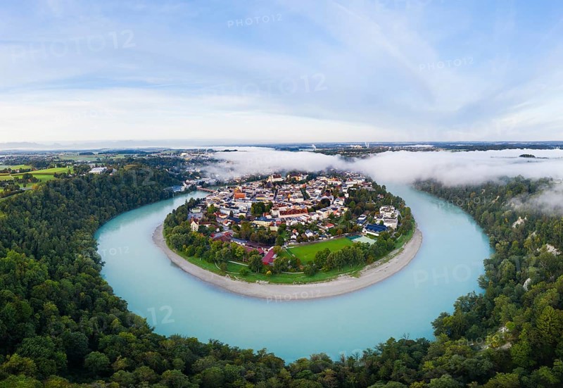 Old town in river bend of the Inn with fog