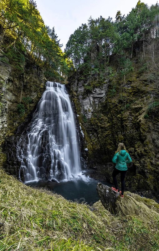Woman standing in front of Bandokoro Waterfall