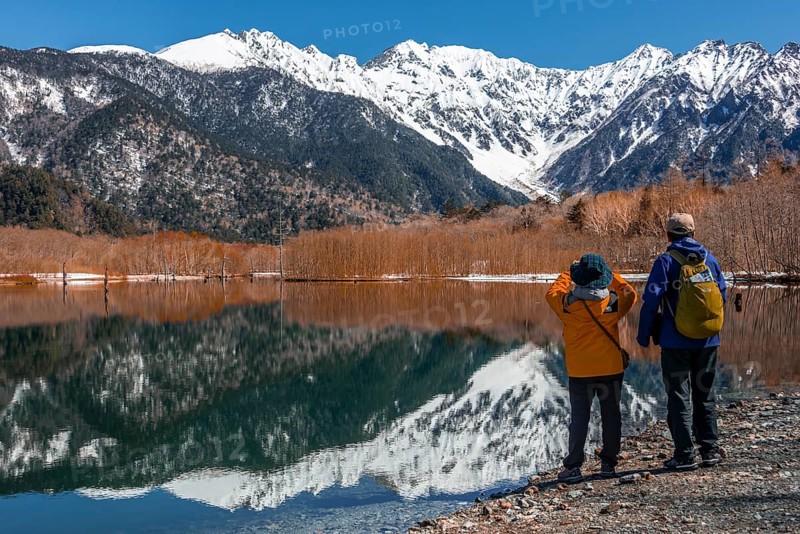 Two Japanese tourists at a lake