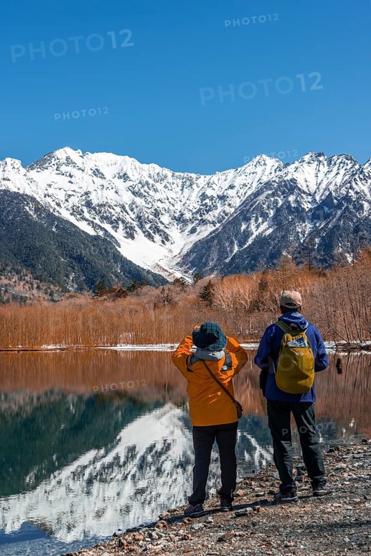 Two Japanese tourists at a lake