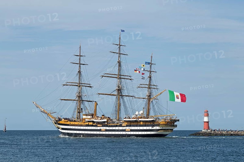 Italian sailing training ship Amerigo Vespucci passes pier lights at the entrance to the Unterwarnow