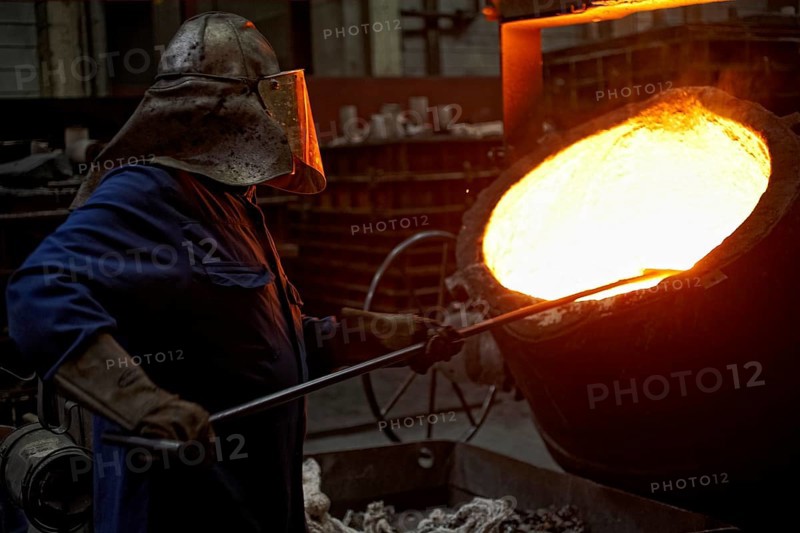 Worker on tanks with liquid iron
