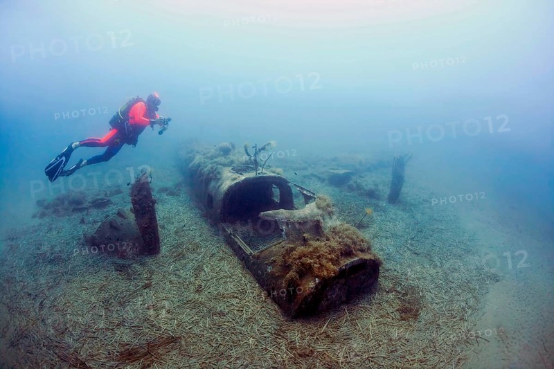 Wreck of a North American B25 bomber Mitchell from World War II with diver