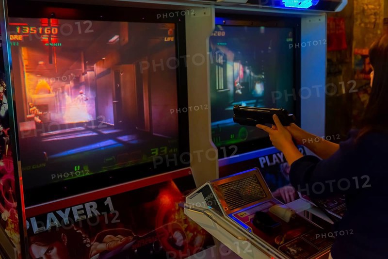 Person holds gun to control a computer game
